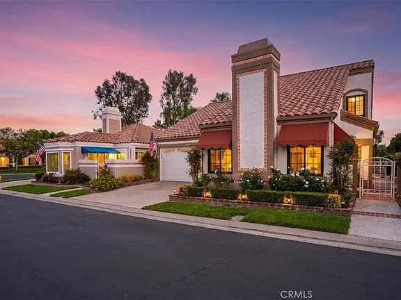Front exterior of 28391 Borgona and courtyard at dusk
